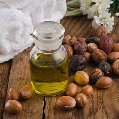 Still life of argan oil with fruit on a natural background. Argan fruits come from Morocco (Africa) and are used as component of many cosmetic products